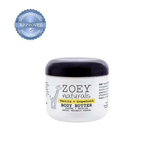 A jar of Zoey Naturals Vanilla + Grapefruit Body Butter on a white background, featuring a blue 'Dermatologist Approved' seal in the top left corner.