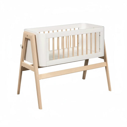 White crib with wooden frame on a white background