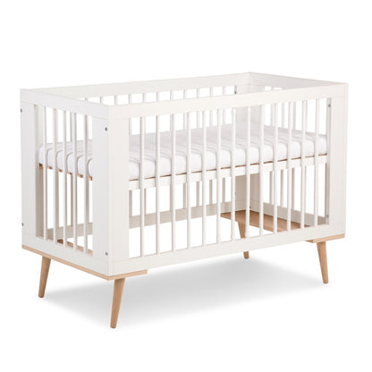 A white crib with wooden legs, featuring a sleek modern design with wooden bars in Lagos, Nigeria