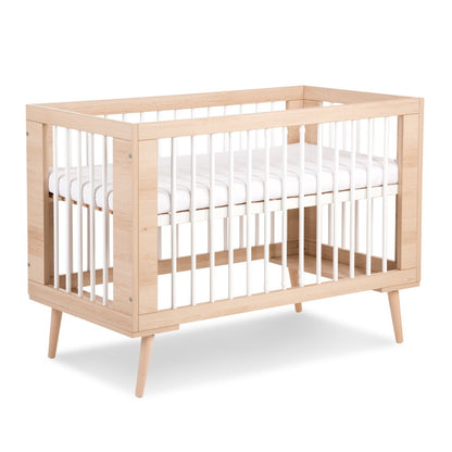 A beechwood crib with white bars, designed for baby and toddler safety at iamspecial.ng in Lagos, Nigeria
